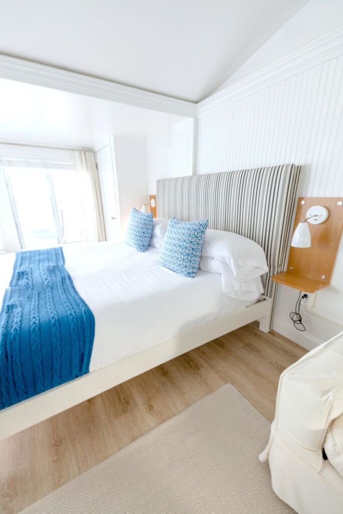 pexels photo 36115837 Elegant hotel room with a minimalist style featuring blue accent pillows and bedding.