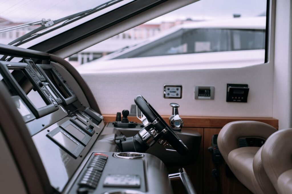 pexels photo 8356431 Interior of a luxury yacht showing steering wheel and advanced controls.